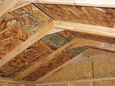 Storage shed roof peaks are reinforced with gussets.